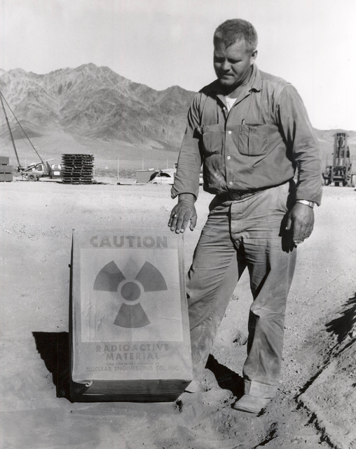 A worker stands by a radioactive materials sign in this undated photo at the former Nuclear Engineering Co. low-level nuclear waste landfill, 11 miles south of Beatty. (Las Vegas Review-Journal file)