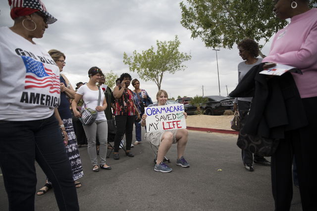 UNLV student Kali Bertelsen, who suffers from a genetic connective tissue disorder, holds a sign outside of Cheyenne High School before a campaign rally for Democratic presidential nominee Hillary ...