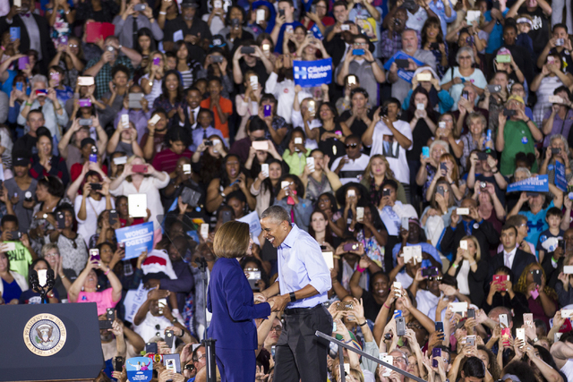 Democratic U.S. Senate candidate Catherine Cortez greets President Barack Obama on stage during a campaign rally for Democratic presidential nominee Hillary Clinton at Cheyenne High School on Sund ...