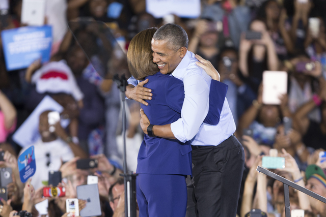 Democratic U.S. Senate candidate Catherine Cortez hugs President Barack Obama on stage during a campaign rally for Democratic presidential nominee Hillary Clinton at Cheyenne High School on Sunday ...