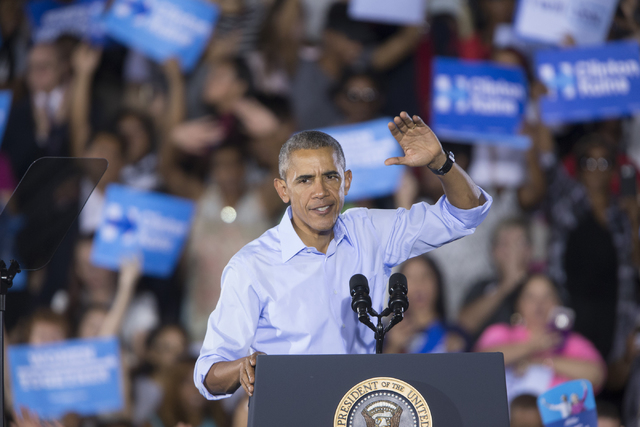 President Barack Obama waves to the crowd at the end of his speech during a campaign rally for Democratic presidential nominee Hillary Clinton at Cheyenne High School on Sunday, Oct. 23, 2016, in  ...