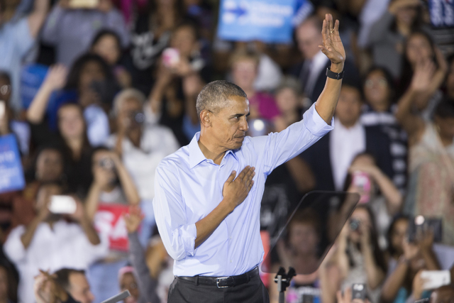 President Barack Obama waves to the crowd at the end of his speech during a campaign rally for Democratic presidential nominee Hillary Clinton at Cheyenne High School on Sunday, Oct. 23, 2016, in  ...