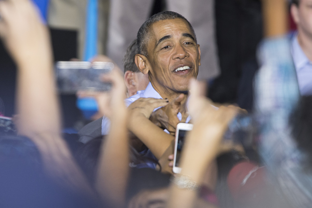 President Barack Obama greets supporters after his speech during a campaign rally for Democratic presidential nominee Hillary Clinton at Cheyenne High School on Sunday, Oct. 23, 2016, in North Las ...