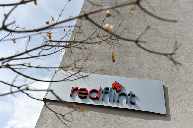 The sign on the exterior is seen at the University of Phoenix's new RedFlint experience center Monday, Oct. 10, 2016, in downtown Las Vegas. The 11,000 square-foot education campus will provide an ...