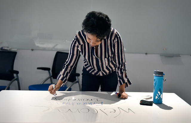 Managing director Shavonnah Tira Collins, of University of Phoenix's new RedFlint experience center, speaks of the upcoming opening as she makes notes on a writable table Monday, Oct. 10, 2016, in ...