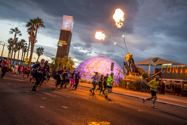 The mantis at Container Park shoots fire as running pass by during the Rock-n-Roll Marathon on Sunday, Nov. 15, 2015. (Joshua Dahl/Las Vegas Review-Journal)