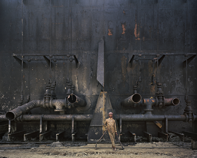 A worker at the shipbreaking yards in Chittagong, Bangladesh, stares into photographer Edward Burtynsky's camera in 2000 for an image featured in "The End of Oil" section of "Oil," which continues ...