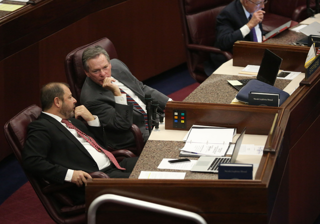 Majority Floor Leader Paul Anderson, left, speaks with Assemblyman Kyle James Stephens during day one of the 30th Special Session of the Nevada Legislature, Monday, Oct. 10, 2016 in Carson City, N ...