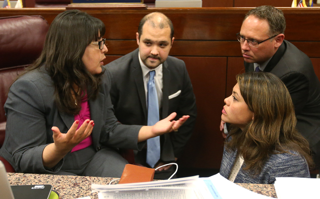 Nevada Assembly Democrats from left, Irene Bustamante Adams, Jakob Stewart, with the Assembly Democratic Caucus, Assembly members Mike Sprinkle and Teresa Benitez-Thompson talk on the Assembly flo ...