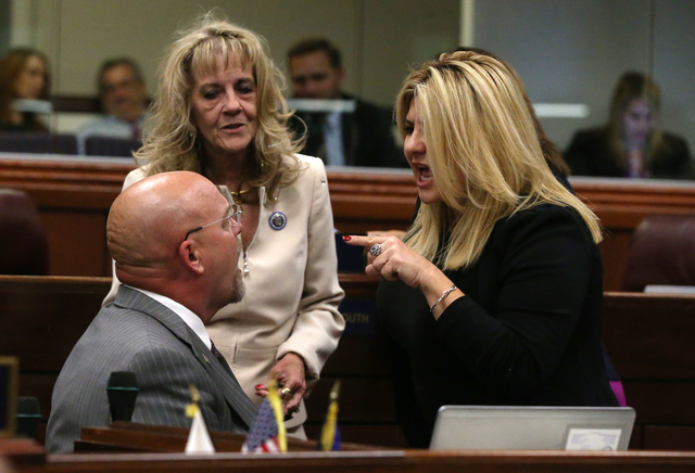Nevada Assembly Republicans, from left, Ira Hansen, Jill Dickman and Michele Fiore talk on the Assembly floor during a special session at the Nevada Legislature in Carson City, Nev. on Thursday, O ...