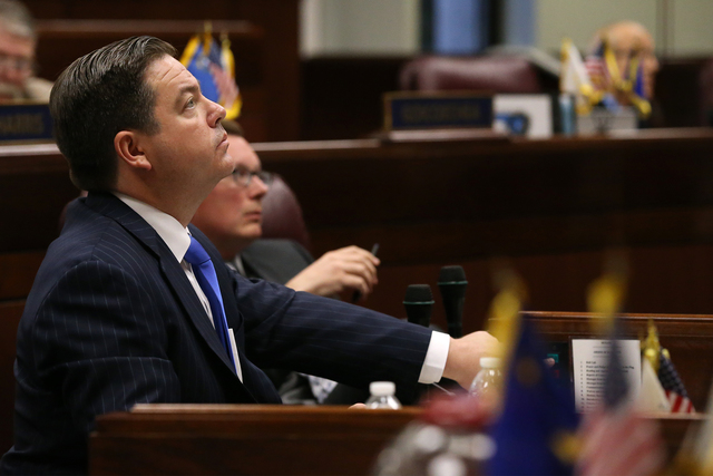 Nevada Senate Majority Leader Michael Roberson, R-Henderson, watches votes tally on the big screen on the Senate floor on a proposal to help fund a football stadium and convention center improveme ...