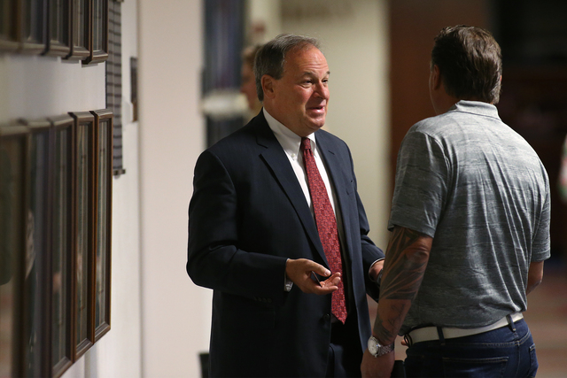Nevada Treasurer Dan Schwartz, left, works in the hallways of the Nevada Legislature in Carson City, Nev. on Tuesday, Oct. 11, 2016. Lawmakers are considering public funding to build a $1.9 billio ...