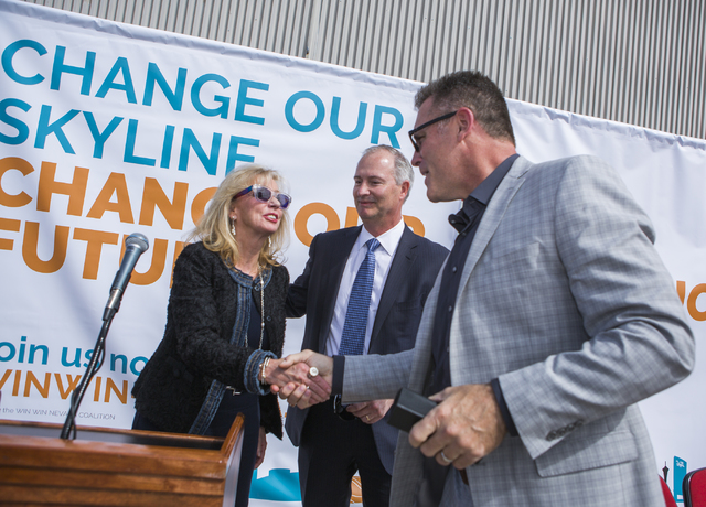 Caesars Entertainment executive Jan Jones Blackhurst, left, shakes hands with former Oakland Raider defensive end Howie Long, during a rally in support of the stadium Monday, Oct. 3, 2016, at Thom ...