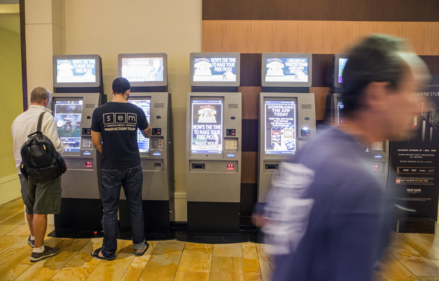 People use the Boarding Pass kiosks, Tuesday, Oct. 25, 2016, at Red Rock Resort. Beginning Nov. 1, Station Casinos will offer points for gaming, dining, spa and hotel spent at its properties. Jeff ...