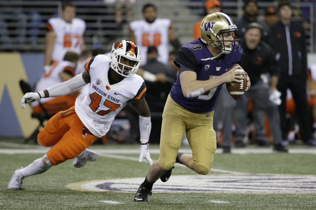Washington quarterback Jake Browning in action against Oregon State in an NCAA college football game Saturday, Oct. 22, 2016, in Seattle. (Elaine Thompson/AP)