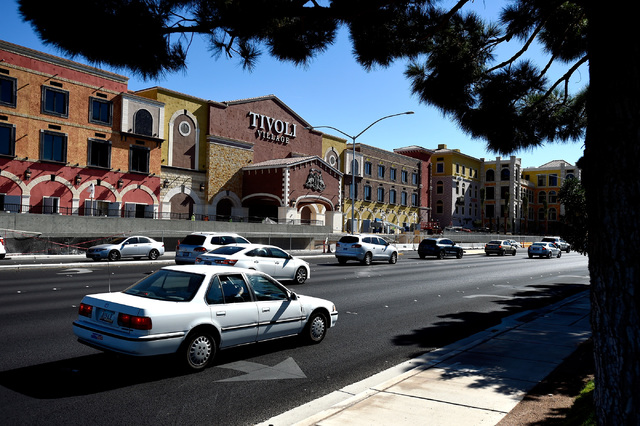 Vehicle traffic travels along Rampart Boulevard near Tivoli Village, Friday, Oct. 21, 2016, in Las Vegas. An additional 350,000 square-foot of retail and office space is schedule to open at the sh ...