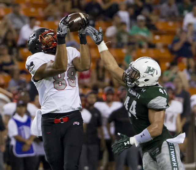 UNLV tight end Andrew Price (88) catches a pass while defended by Hawaii linebacker Russell Williams Jr. (44) during the second quarter of an NCAA college football game, Saturday, Oct. 15, 2016, i ...