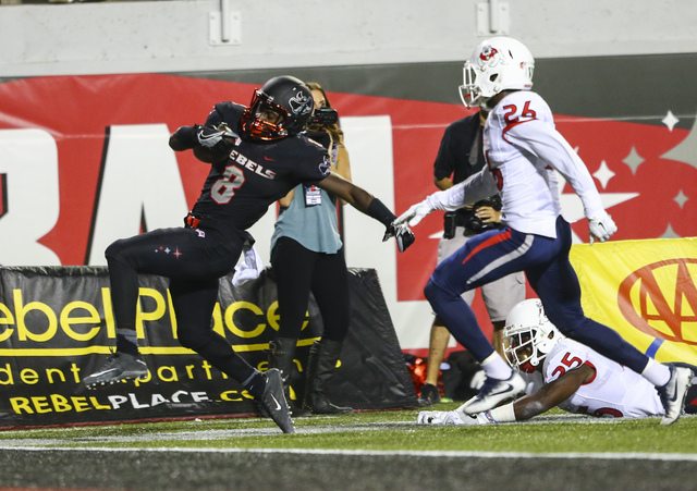 UNLV running back Charles Williams (8) steps out of bounds just before the end zone as Fresno State defensive back Alan Wright (26) defends during a football game at Sam Boyd Stadium in Las Vegas ...