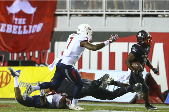 UNLV wide receiver Darren Woods Jr. (10) gets past Fresno State defense, including Fresno State linebacker James Bailey (7), during a football game at Sam Boyd Stadium in Las Vegas on Saturday, Oc ...