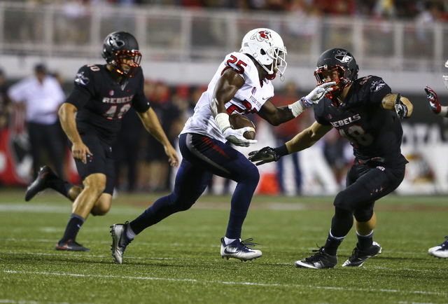 UNLV linebacker Bailey Laolagi (48) looks to stop Fresno State running back Austin Harper (25) during a football game at Sam Boyd Stadium in Las Vegas on Saturday, Oct. 1, 2016. Chase Stevens/Las ...