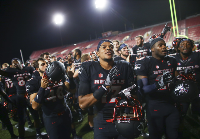 UNLV players, including defensive back Evan Austrie (17), celebrate after defeating Fresno State in a football game at Sam Boyd Stadium in Las Vegas on Saturday, Oct. 1, 2016. UNLV won 45-20 again ...