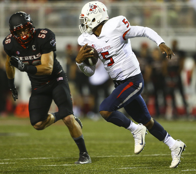 Fresno State quarterback Chason Virgil (5) looks to get past UNLV linebacker Ryan McAleenan (56) during a football game at Sam Boyd Stadium in Las Vegas on Saturday, Oct. 1, 2016. Chase Stevens/La ...