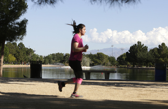 A woman jogs at Sunset Park in Las Vegas. (Bizuayehu Tesfaye/Las Vegas Review-Journal Follow @bizutesfaye)