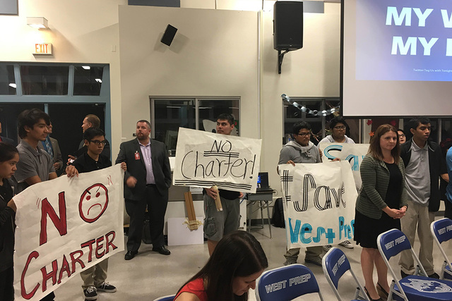 Students from West Preparatory Institute for Academic Excellence in Las Vegas hold signs to protest the possibility of a charter-school takeover, Tuesday, Oct. 18, 2016, as Achievement School Dist ...