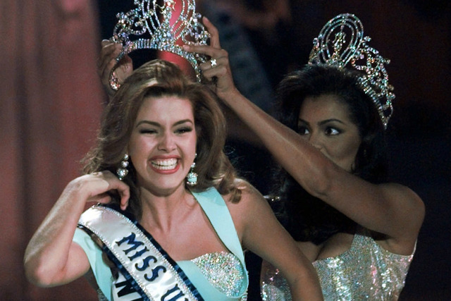 In this May 17, 1996, file photo, the new Miss Universe Alicia Machado of Venezuela reacts as she is crowned by the 1995 winner Chelsi Smith at the Miss Universe competition in Las Vegas. (Eric Dr ...