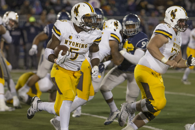 Wyoming running back Brian Hill runs in the second half of an NCAA college football game against UNR on Saturday, Oct. 22, 2016 in Reno. (Tom R. Smedes/AP)