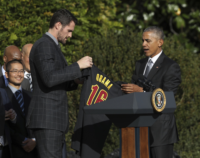 Cleveland Cavaliers forward Kevin Love presents President Barack Obama with the team jersey during a ceremony honoring the 2016 NBA basketball champions, Thursday, Nov. 10, 2016, on the South Lawn ...