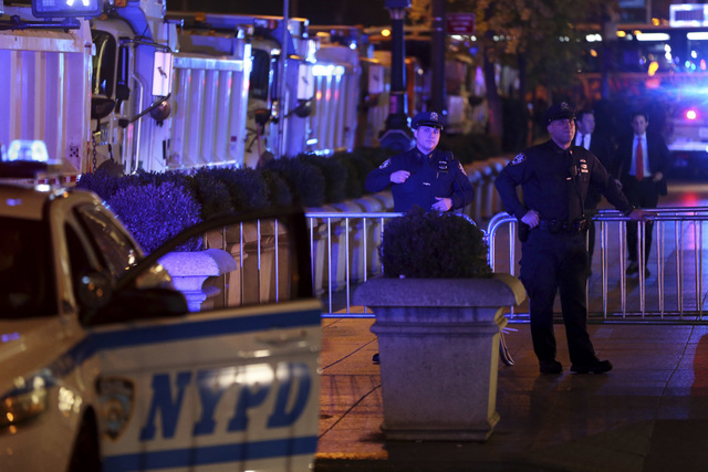 In this Nov. 8, 2016 file photo, New York City Police and sanitation trucks block off Trump Tower, the primary residence of Republican presidential candidate Donald Trump, as a security measure on ...