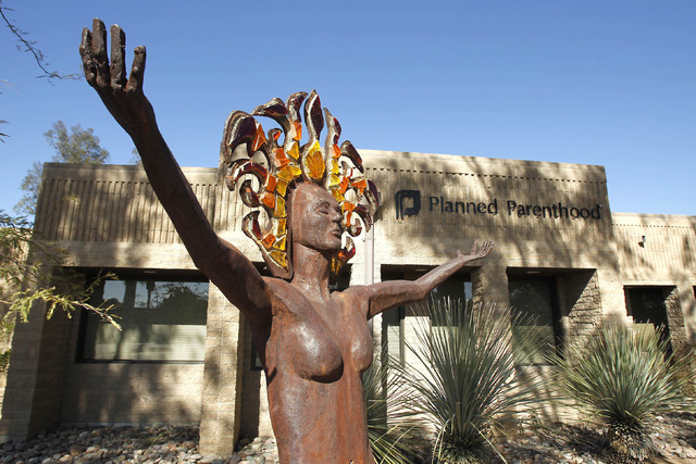 A statue representing women's empowerment stands in front of a Planned Parenthood facility Jan. 23, 2011, in Tucson, Ariz. The number and rate of abortions tallied by federal authorities have fall ...