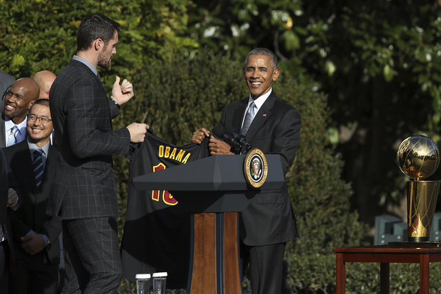 Cleveland Cavaliers' forward Kevin Love presents President Barack Obama with the team jersey during a ceremony honoring the 2016 NBA Champion basketball team, Thursday, Nov. 10, 2016, the South La ...