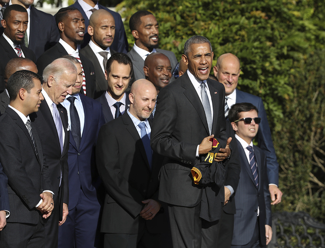 President Barack Obama holds a Cleveland Cavaliers basketball team jersey presented to him by forward Kevin Love during a ceremony honoring the 2016 NBA basketball champions, Thursday, Nov. 10, 20 ...