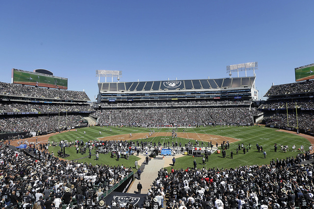 Fans at Oakland Alameda County Coliseum watch the opening kickoff during the first half of an NFL football game between the Oakland Raiders and the Atlanta Falcons in Oakland, Calif., Sunday, Sept ...