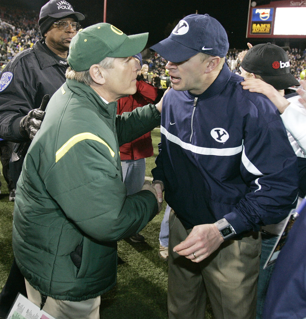 Oregon coach Mike Bellotti, left, congratulates Brigham Young coach Bronco Mendenhall following BYU's 38-8 win in the Las Vegas Bowl football game in Las Vegas on Thursday, Dec. 21, 2006. (AP Phot ...