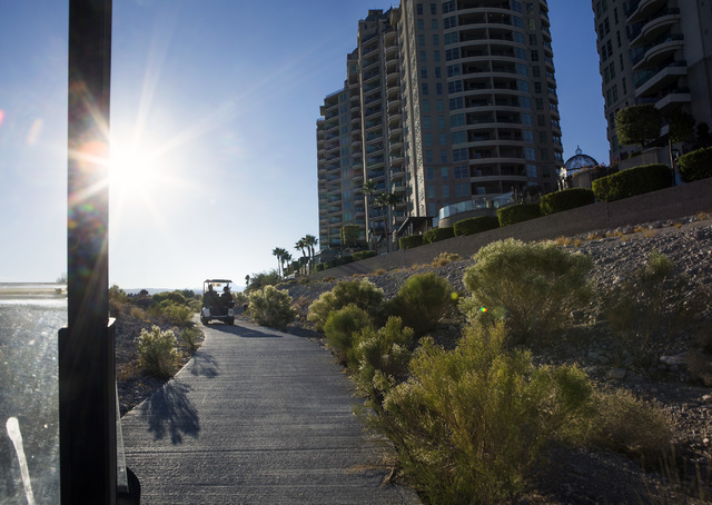 Golf carts travel past Queensridge Towers at Badlands Golf Course on Wednesday, Oct. 9, 2016. Residents are concerned they will loose their views if the controversial, high-density development is  ...