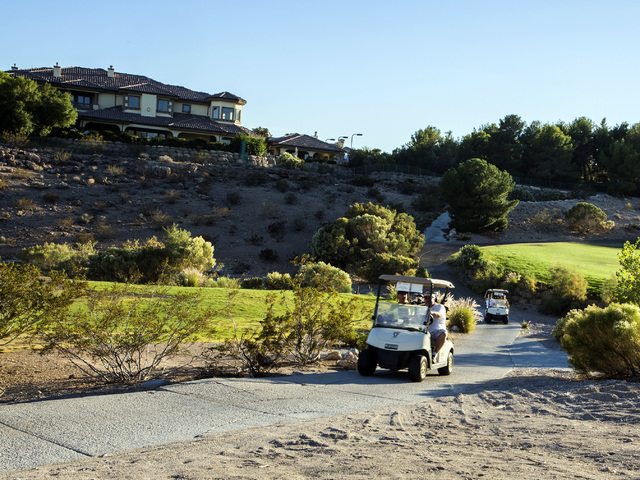 Golf carts travel along the trail at Badlands Golf Course on Wednesday, Oct. 9, 2016. Residents are concerned they will loose their views if the controversial, high-density development is approved ...