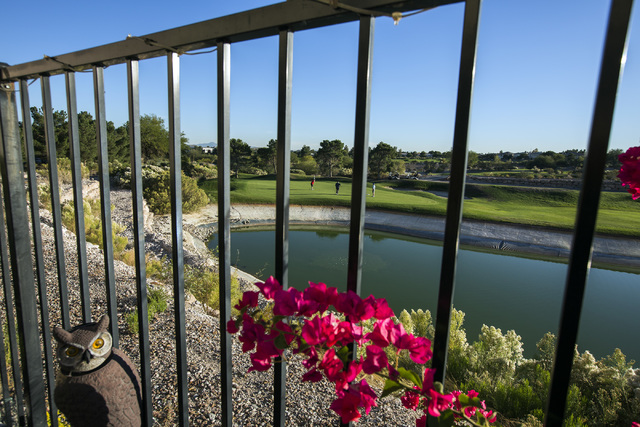 Backyard views from Tudor Park development show golfers putting at the Badlands Golf Course on Thursday, Oct. 10, 2016. Residents are concerned they will loose their views if the controversial, hi ...