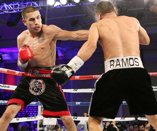 Andy Vences, left, of San Jose, hits Casey Ramos, of Austin, Tex., during a super featherweight boxing bout at T.I. hotel-casino Friday, Nov. 4, 2016, in Las Vegas. Vences won by unanimous technic ...