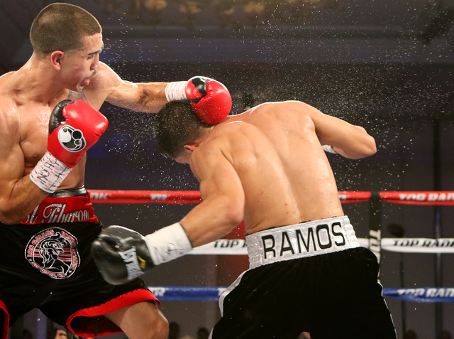 Andy Vences, left, of San Jose, makes contact with Casey Ramos, of Austin, Tex., during a super featherweight boxing bout at T.I. hotel-casino Friday, Nov. 4, 2016, in Las Vegas. Vences won by una ...