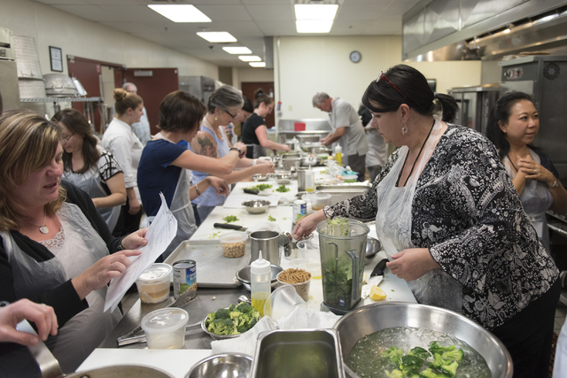 Participants prepare meals based on patient casework during a cooking class for the Primary Care Cardiometabolic Risk Summit at the Culinary Academy of Las Vegas, Sunday, Oct. 16, 2016. The cookin ...