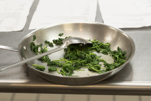 Sauteed spinach sits in a pan during a cooking class for the Primary Care Cardiometabolic Risk Summit at the Culinary Academy of Las Vegas, Sunday, Oct. 16, 2016. The cooking class is called & ...
