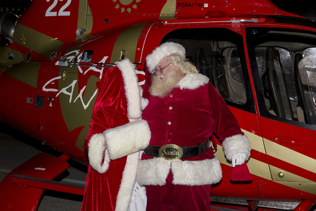 Santa Clause is greeted by Mrs. Clause after arriving for the 25th annual tree lighting ceremony at Opportunity Village in a helicopter, Friday, Nov. 25, 2016, Las Vegas. (Elizabeth Page Brumley/L ...