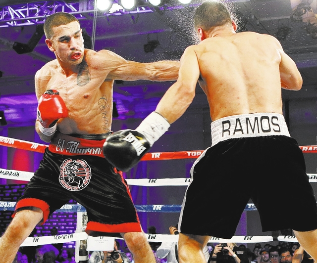 Andy Vences, left, of San Jose, hits Casey Ramos, of Austin, Tex., during a super featherweight boxing bout at T.I. hotel-casino Friday, Nov. 4, 2016, in Las Vegas. Vences won by unanimous technic ...