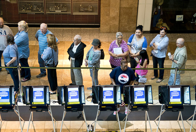 Voters stand in line to be among the first to vote in Nevada during early voting at the Galleria at Sunset in Henderson on Oct. 22, 2016. (Daniel Clark/Las Vegas Review-Journal)