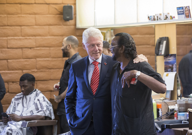 Former President Bill Clinton shakes hands with Mac Smith, Jr., owner of Hair Unlimited, on Thursday, Nov. 3, 2016, in Las Vegas. President Clinton was in Las Vegas for a rally at Cox Pavilion for ...