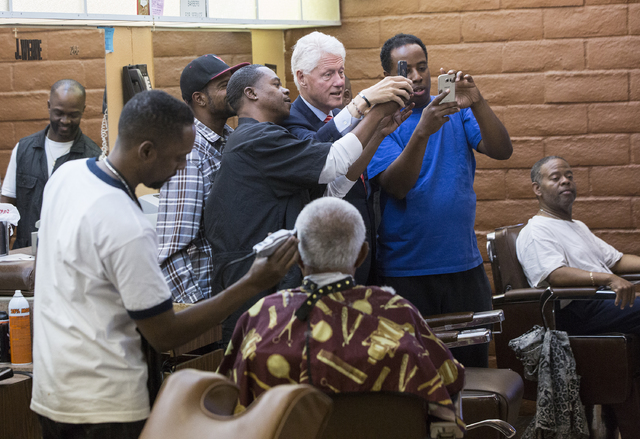 Former President Bill Clinton takes a selfie with D'Mario Osley, right, at Hair Unlimited on Thursday, Nov. 3, 2016, in Las Vegas. President Clinton was in Las Vegas for a rally at Cox Pavilion fo ...