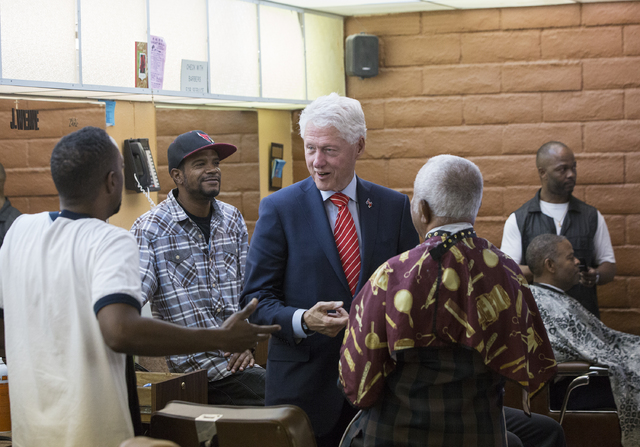 Former President Bill Clinton interacts with patrons at Hair Unlimited on Thursday, Nov. 3, 2016, in Las Vegas. President Clinton was in Las Vegas for a rally at Cox Pavilion for his wife, Democra ...